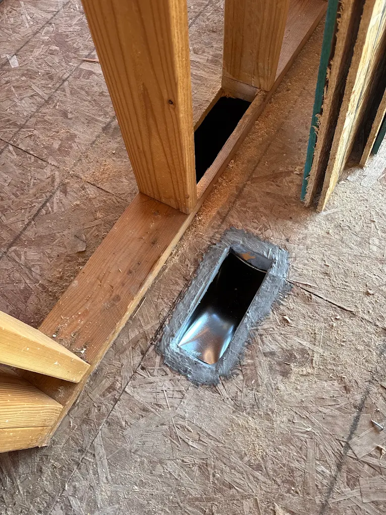 Sealed floor register boot roughed in through a subfloor